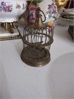 Small brass bird in a birdcage