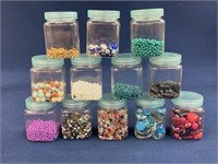 Plastic storage jars with assorted beads And
