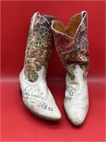 Autographed, cowboy boots. It’s a mystery.