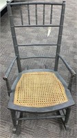 Grey painted rocking chair with woven seat