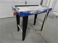 Battery operated air hockey game; table top is 16"