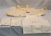 Coleman canvas apron + 3 vinyl aprons, new