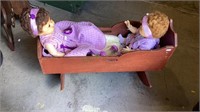 Vintage wooden doll cradle with two baby dolls -