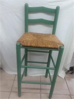Green barstool chair with wicker seat