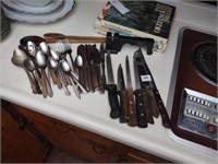 Assorted knives, flatware, wooden spoons, knife
