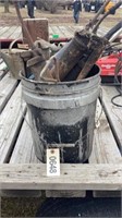 Assortment of grease guns in bucket