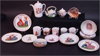 A large group of doll dishes including plates,