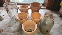 Small clay planting pots and glass jars