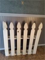 White wooden picket fence shelf.