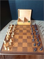 Wooden chess board and game pieces. A few pieces