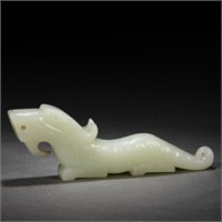 A CHINESE CARVED WHITE JADE MYTHICAL BEAST