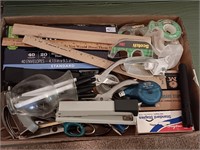 Box of office supplies, scissors, staplers and