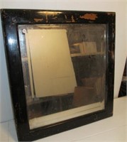 Framed beveled mirror. Measures 27" x 29".