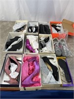 Assortment of high heels and shoes, most appear