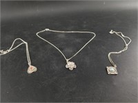 3 Silver pendants and chains