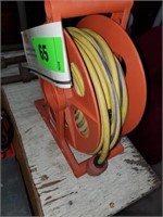 YELLOW EXTENSION CORD ON REEL