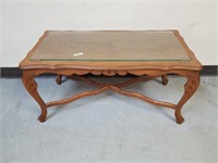 Solid wood coffee table with glass top.