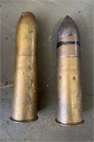 Two 7 inch brass bullets, one is dated February