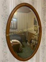 Oval wood framed beveled mirror