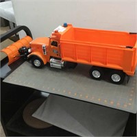 Orange DOT dump truck with front blade