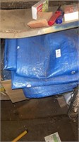 Box of tarps and metal shelving unit