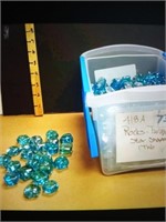 Tub of turquoise star shaped rocks