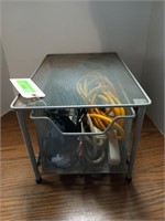 Metal drawer of assorted plugs, power strips,