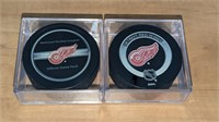2 Detroit Red Wings Official Hockey Pucks in Case