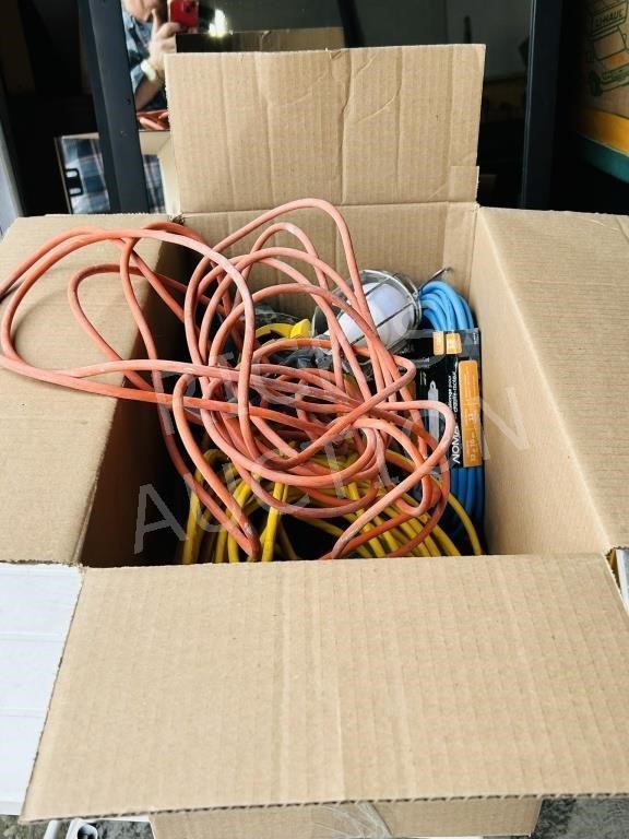 box of various extention cords & trouble light