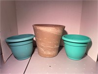 one larger ceramic planter & two blue plastic pots