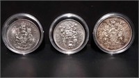 THREE CANADIAN 50 CENT PIECES