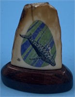 Colored scrimshawed fossilized ivory tip of a bowh