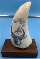 Sperm whale's tooth with scrimshaw of a mountain g