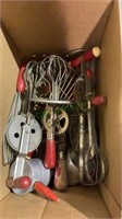 Box of vintage red-handled kitchen utensils.
