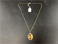 Tiger's eye cabochon set into a pendant and chain