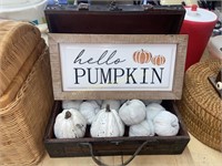 Sign and decorative pumpkins in small trunk