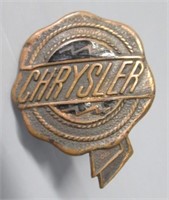 Vintage copper Chrysler emblem.