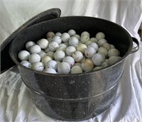 Large cooking pot full of golf balls