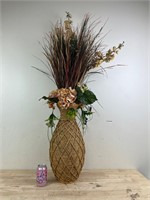 Large woven vase with artificial plant