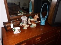 Contents of dresser top: ceramic ducks, dog,