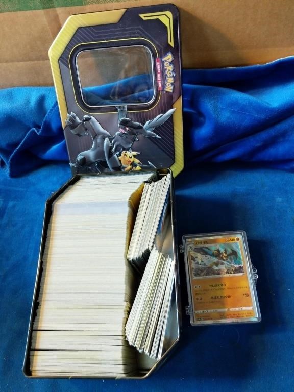 Tin of pokemon energy cards and reprint card.