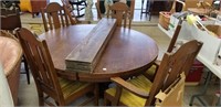 54 in. round oak table with 5 leaves and 5 chairs