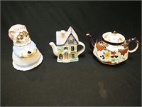 Three teapots: two are figural, one a cat, one a