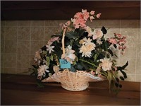 Artificial flower arrangement in basket