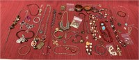 64 Pieces of earth tone jewelry, 20 necklaces, 21