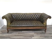 Chesterfield-style green leather tufted sofa