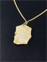 Ancient walrus ivory pendant with small gold nugge