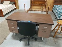 Metal office desk with black roll around chair