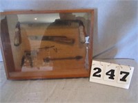Shadow box of draw knife and old tools