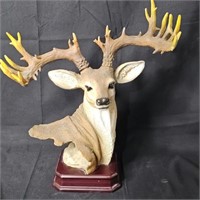 Deer Statue with Antlers on wooden platform.